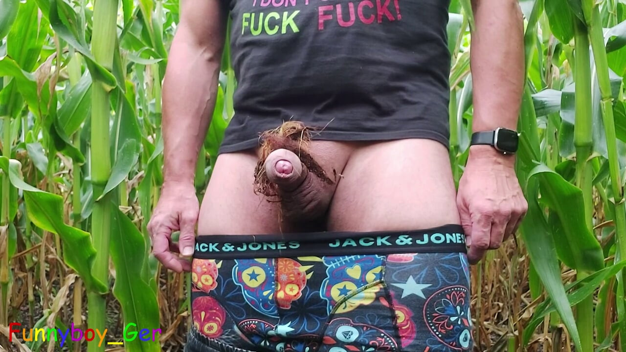 A sexy guy pisses in a cornfield, jerks off his thick cock and engages in other kinky play.