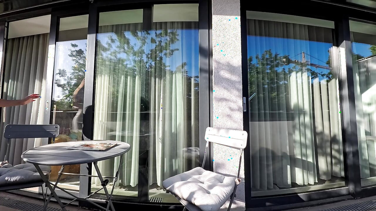 Wonderfully beautiful girl in a summer dress no panties on the balcony shows her tight shaved pussy to the neighbors