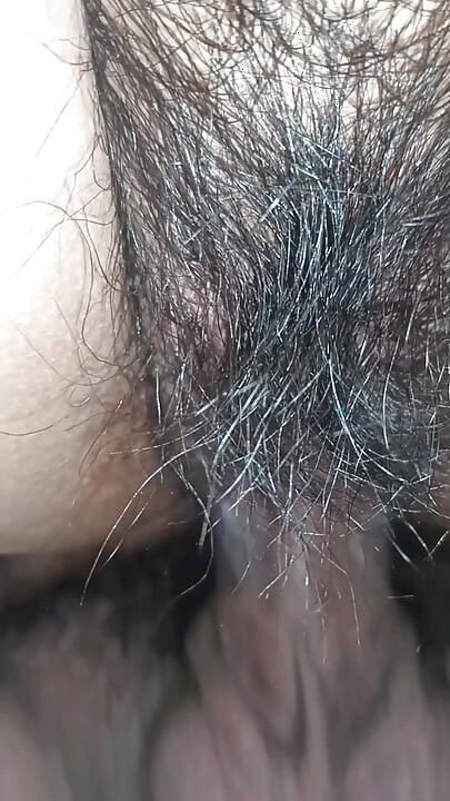 Close up view on a hairy and creamy pussy