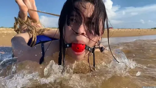 Ball Gagged Latina Hogtied In The Sea