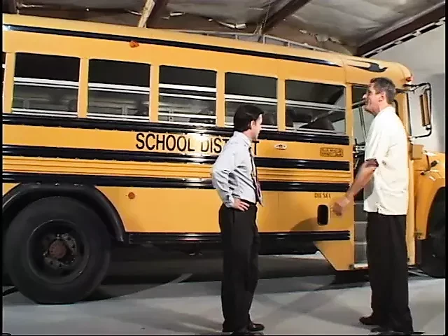 Blond student in pigtails gets fucked by two dudes in the school bus garage
