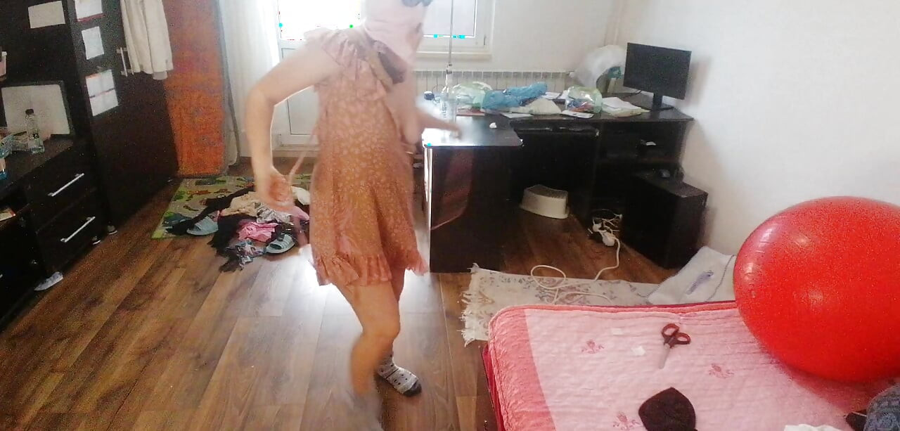 Amateur woman has fun trying on clothes and cutting them.