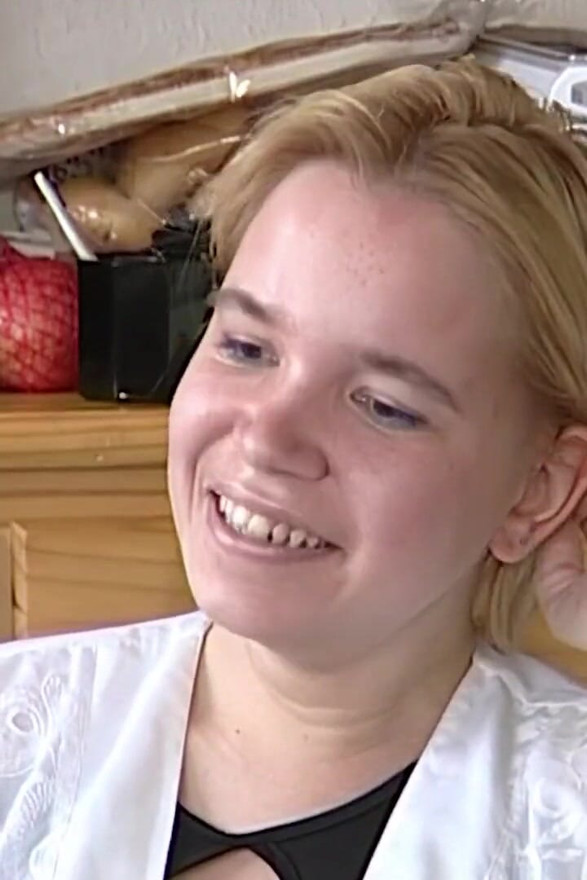 Shy blonde looks down while chatting with lover