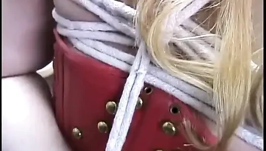 Her tits and hands are roped