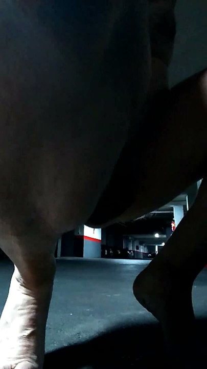 Naked in an underground parking lot