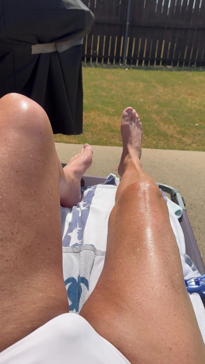 Sissy Cryssi tanning in a bikini with her long sexy legs
