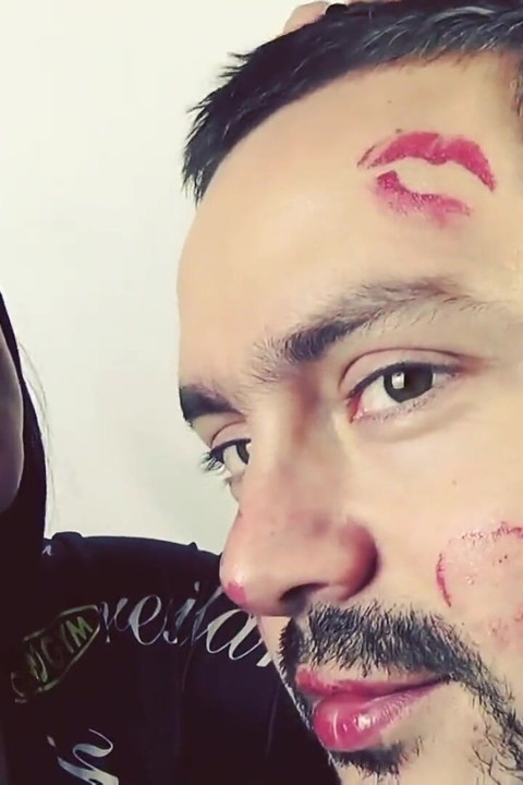 Covering Alex with red shiny lipstick kisses all over his face!