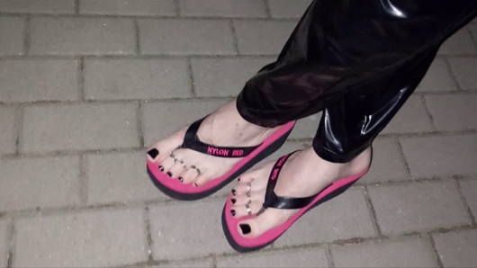 crossdresser in sexy flip-flops and latex leggings