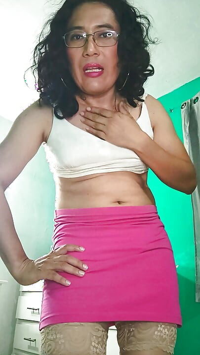Trans girl in pink miniskirt masturbating.