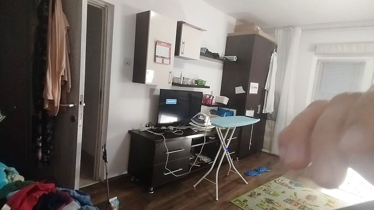 Sexy brunette doing naked chores around the house.