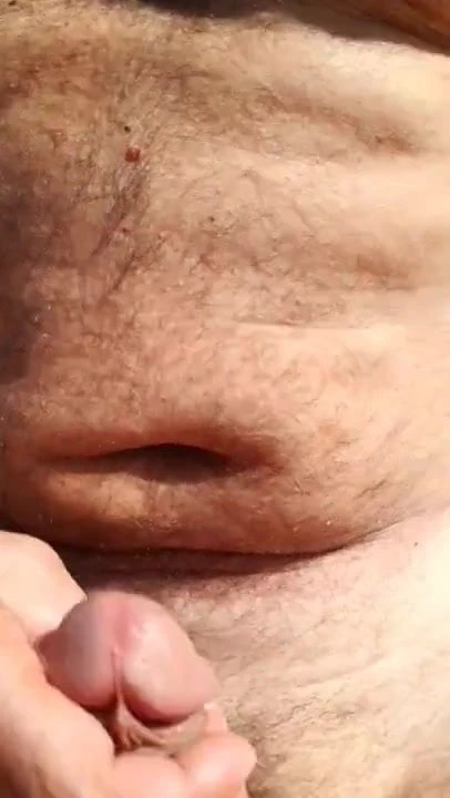 Two mature men have sex on the beach