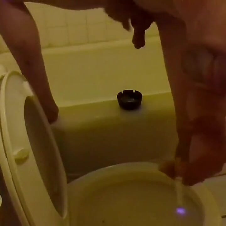 Pissing in the Toilet While Standing on the Bathtub