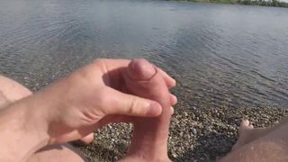 Guy strokes cock on the beach