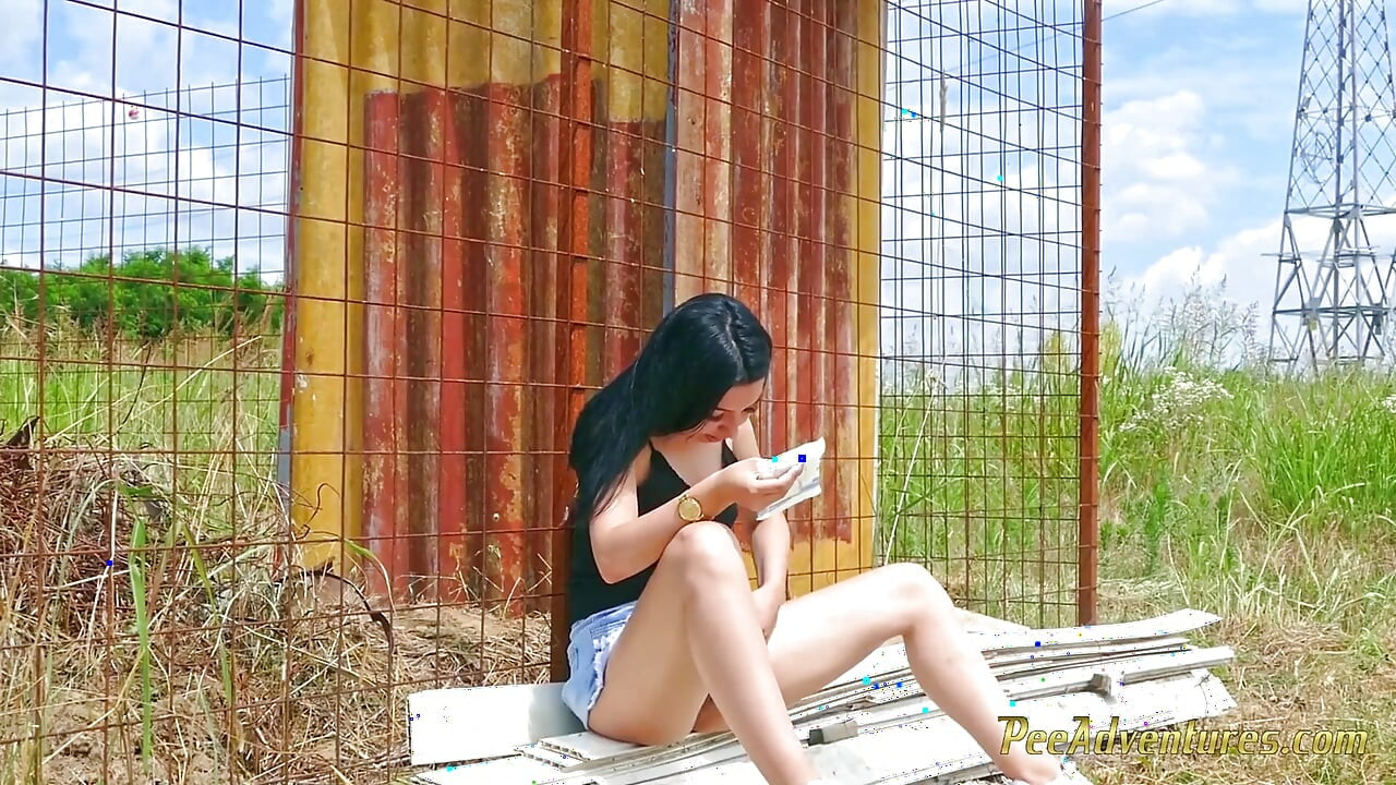 Sexy brunette quick pee next to a house in construction