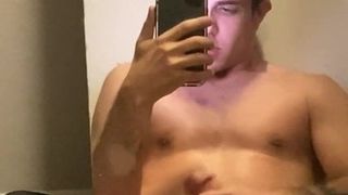 Guy showing in front of the mirror
