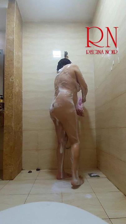 Her peaceful shower routine gets a playful twist as her husband watches from behind the camera. Regina Noir.