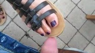 Public cum on dangling sandal