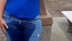 Une femme mouille un jean dans un parc