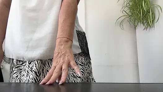 Horny stepmom Michelle puts her sexy feet in high heels on the desk.