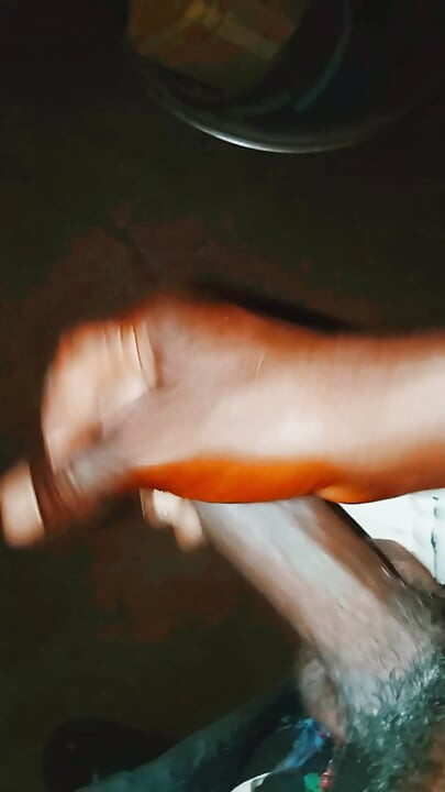 An African guy rubbing his big dick inside his room