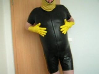 in my tight rubber short suit showing my fat man tits