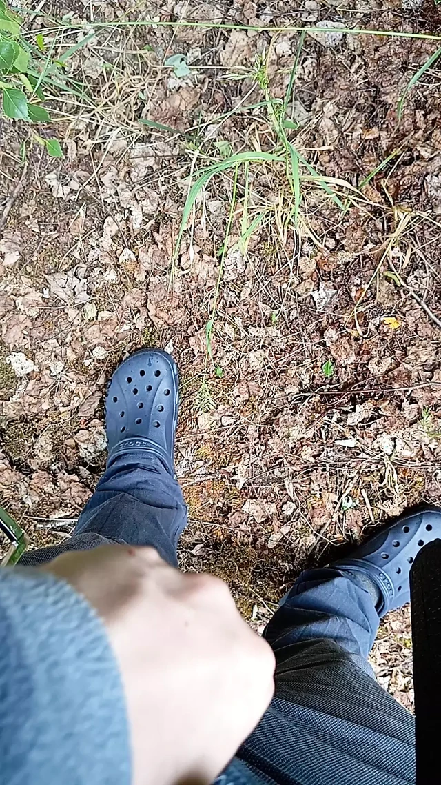 Boy pissing in the forest