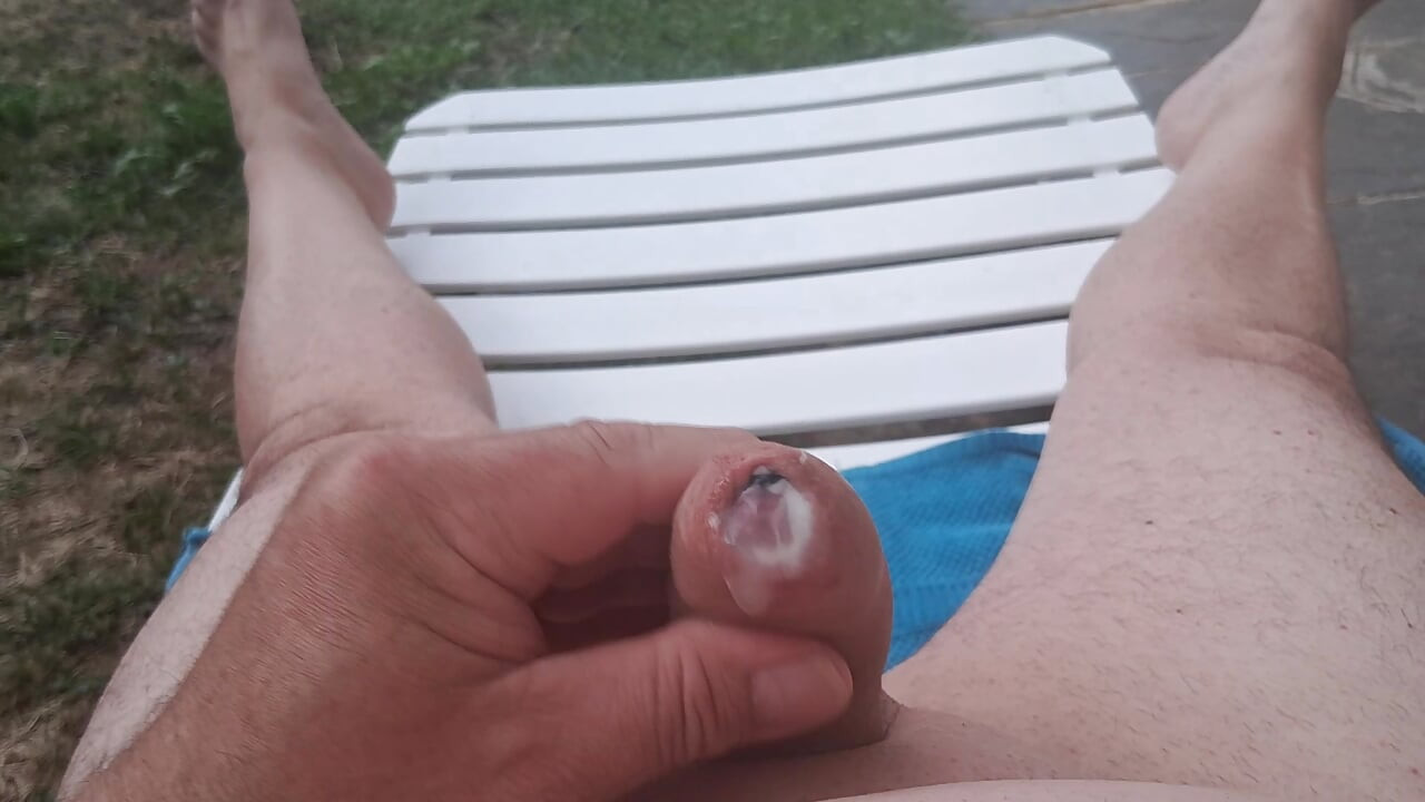 Penis massaging by the pool, with cumshot