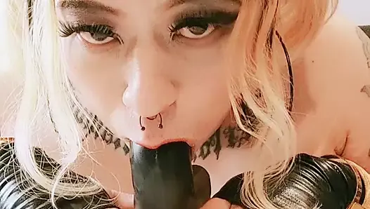 Sucking on a big black dildo