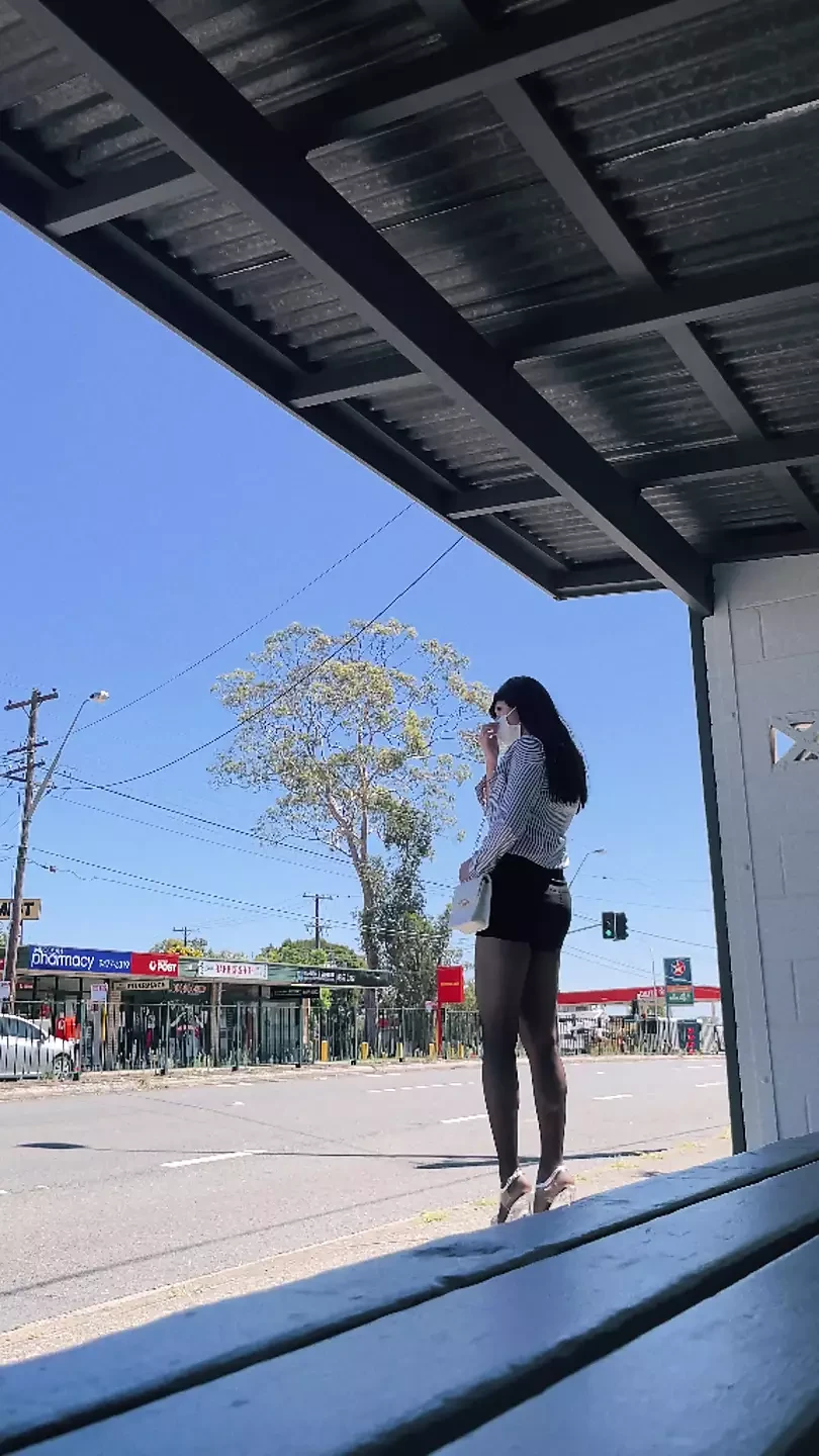 asian crossdresser wearing stockings at bus stop
