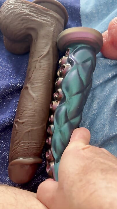 The latex titty slut pushes three monstrous dildos in a row!