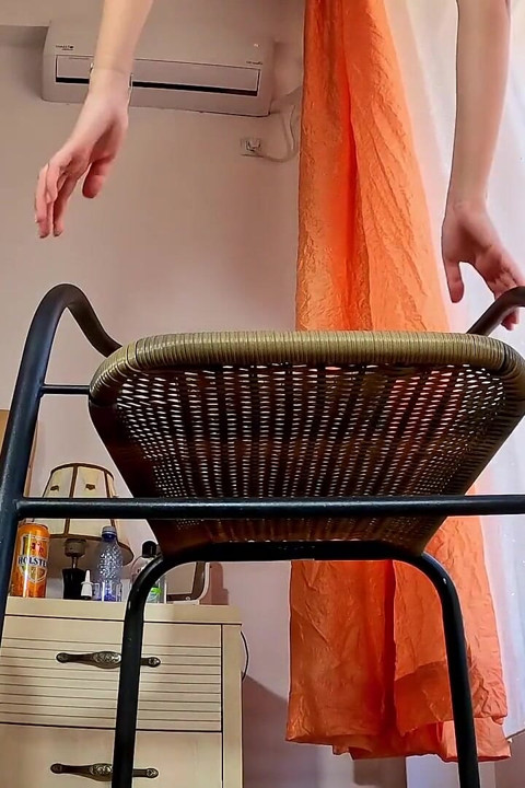 A desperate brunette pee through a chair