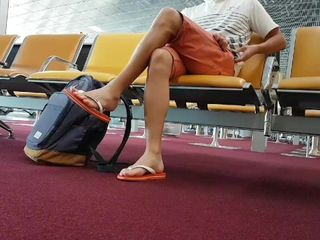 Boy put on flip flops and anklet in airport
