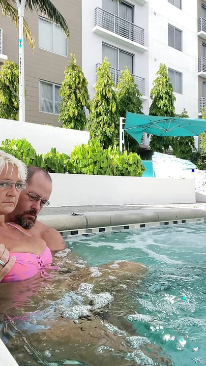 Getting frisky in the hot tub. Boob play.
