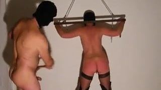 Nude Master punishing his submissive wife.