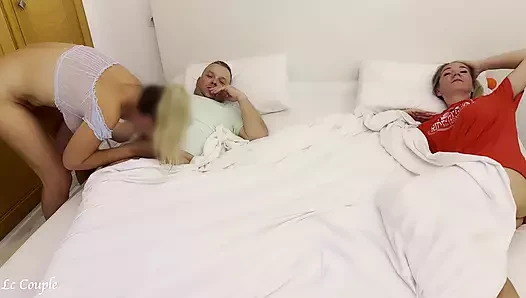 Girlfriend sneaks into swinger couple bedroom to fuck husband