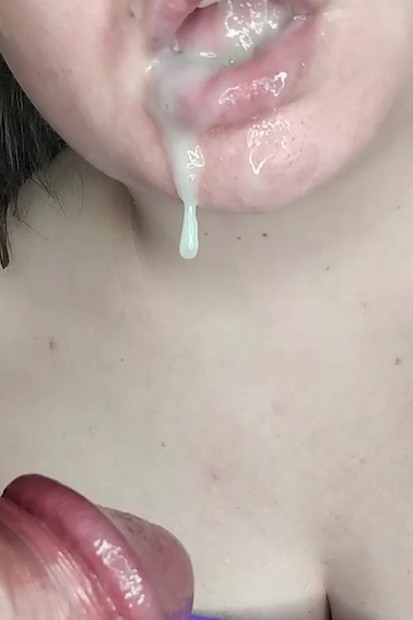She licks and swallows cum after a cumshot in her mouth.