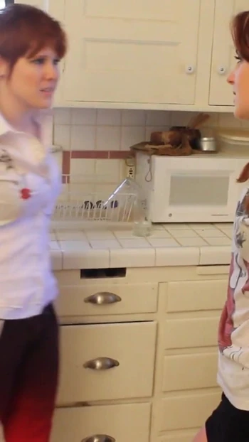 Unforgettable moment from "Short haired babe licks randy redhead's pussy in the kitchen"