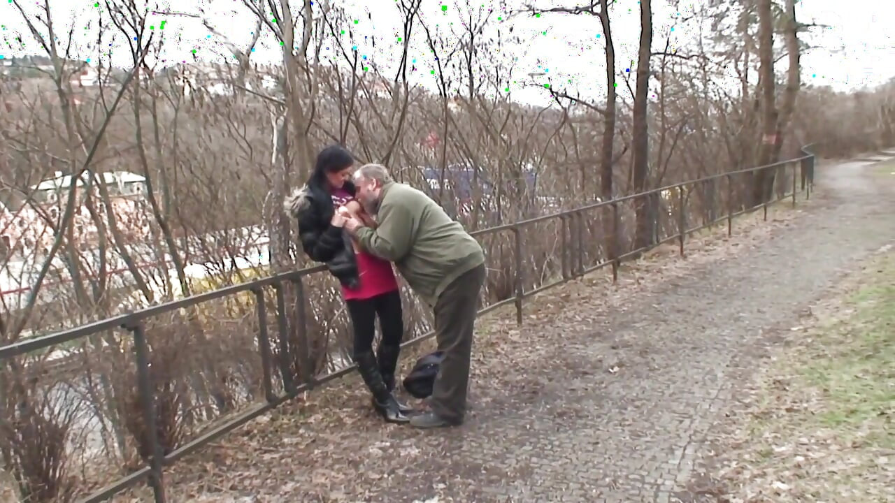 It's cold in the park and the young brunette with small natural tits gets warmed up by an old man and swallows all the cum