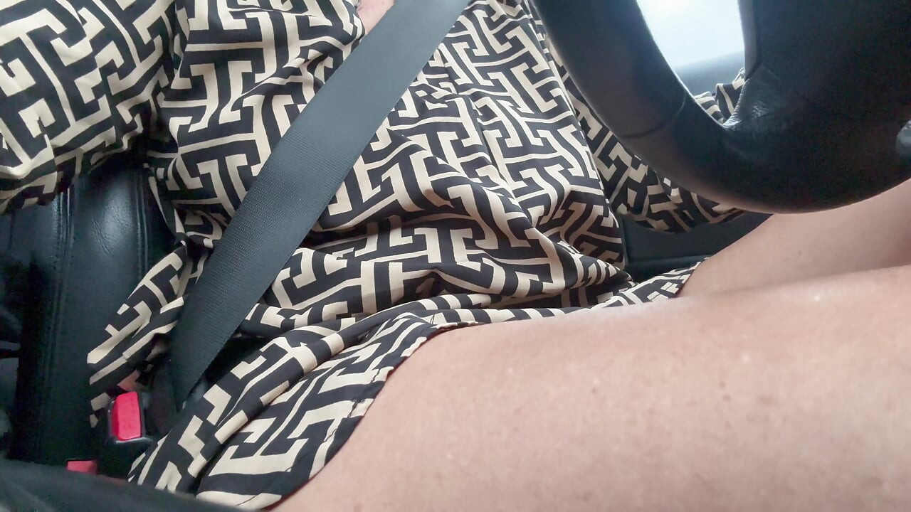 Elegant sexy stepmom drives cheerfully to work in the morning