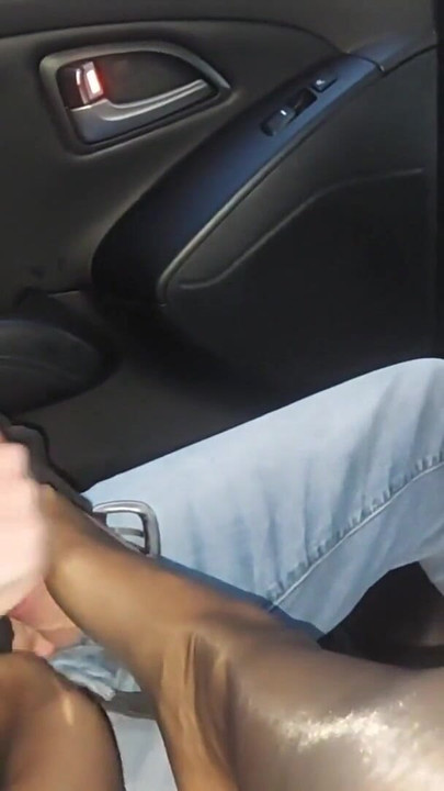 Mature stepmom gives her stepson a nylon footjob in the car in public | Clip 1