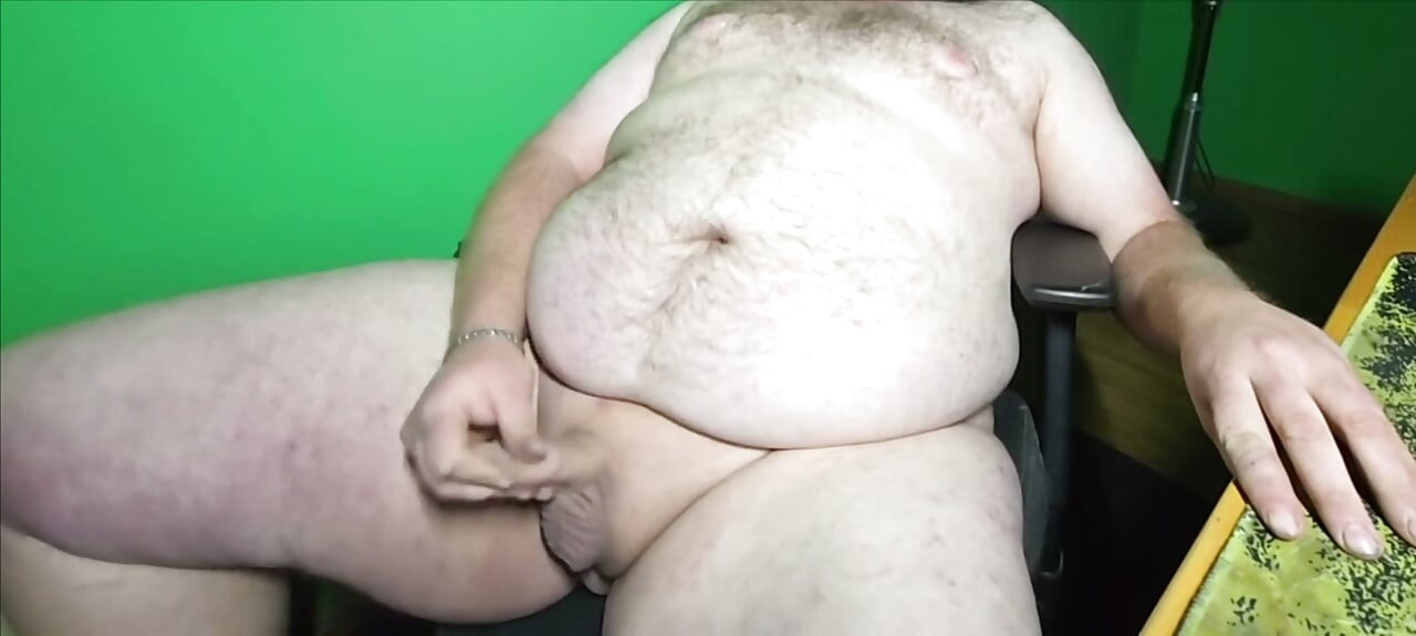 A fat boy with a small dick is masturbating.