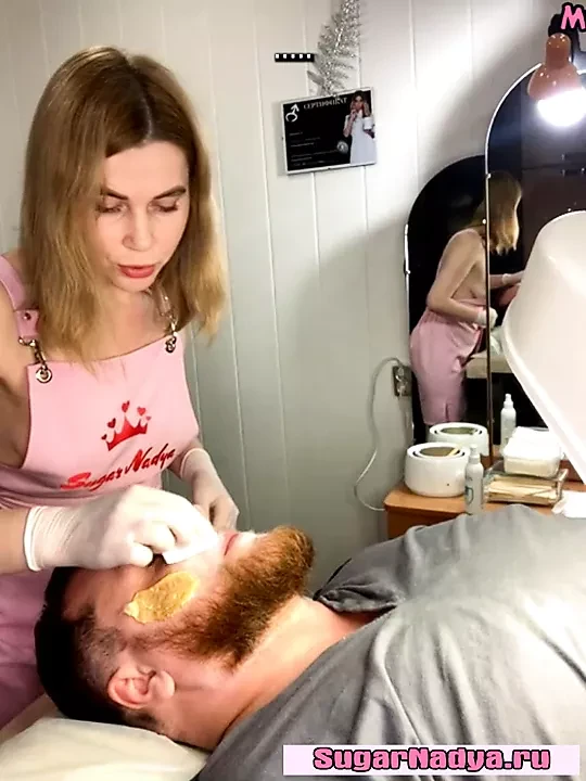 Classy blonde waxes a man's face, her gorgeous breasts popping
