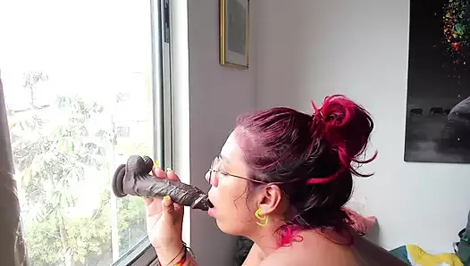 Naughty latina suck a BBC dildo in the window
