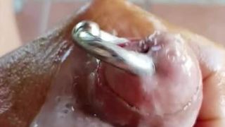 Wanking oiled pierced hard cock and cum