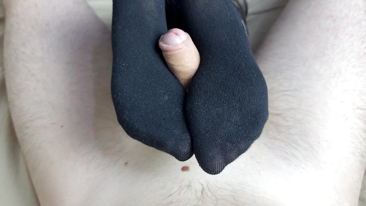 Female domination of cock with feet from mistress in latex suit