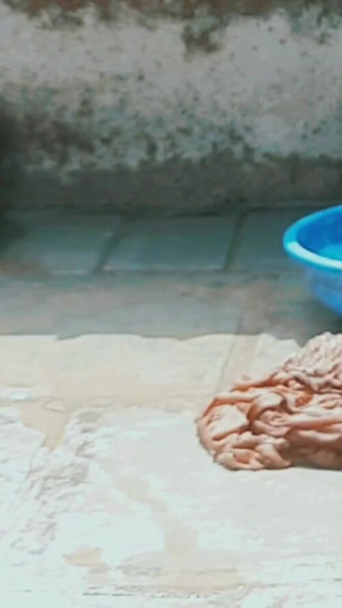 In the country's bathroom of the village, the elder sister-in-law's stepsister is soaking her saree in water and bathing naked in the open. | Clip 1