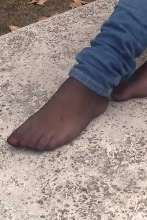 Sexy brunette loves playing with her feet outdoors