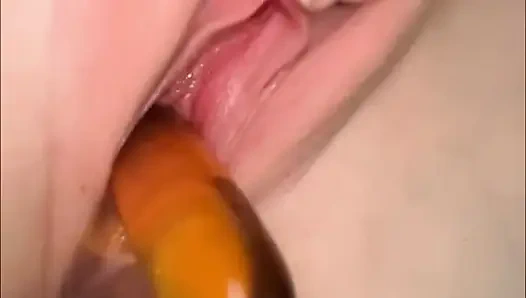 Cute girl pisses in a bottle and pours it back into her pussy