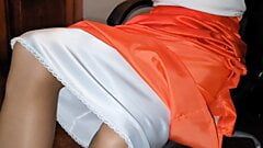 Long lined orange satin skirt with a white silky half slip.
