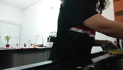 Woman teasing while washing dishes. She loves to transmit to the voyeurs on duty